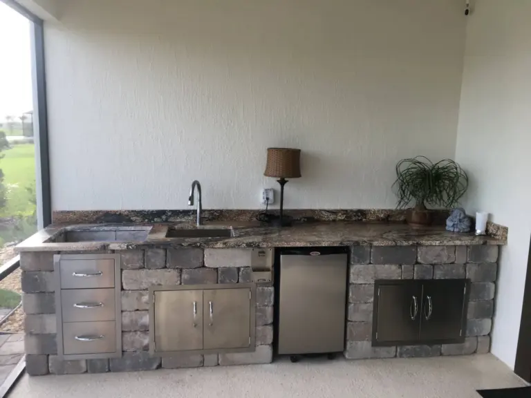 Outdoor kitchen project with a surrounding paver surface.