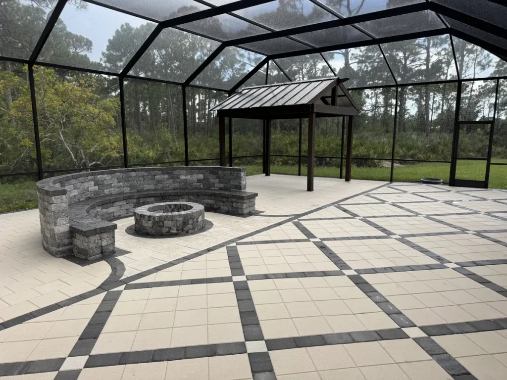 Cream and charcoal paving with curved gray block seating and a circular masonry feature